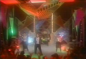 A screen shot from its music video. A screen shot from its music video.